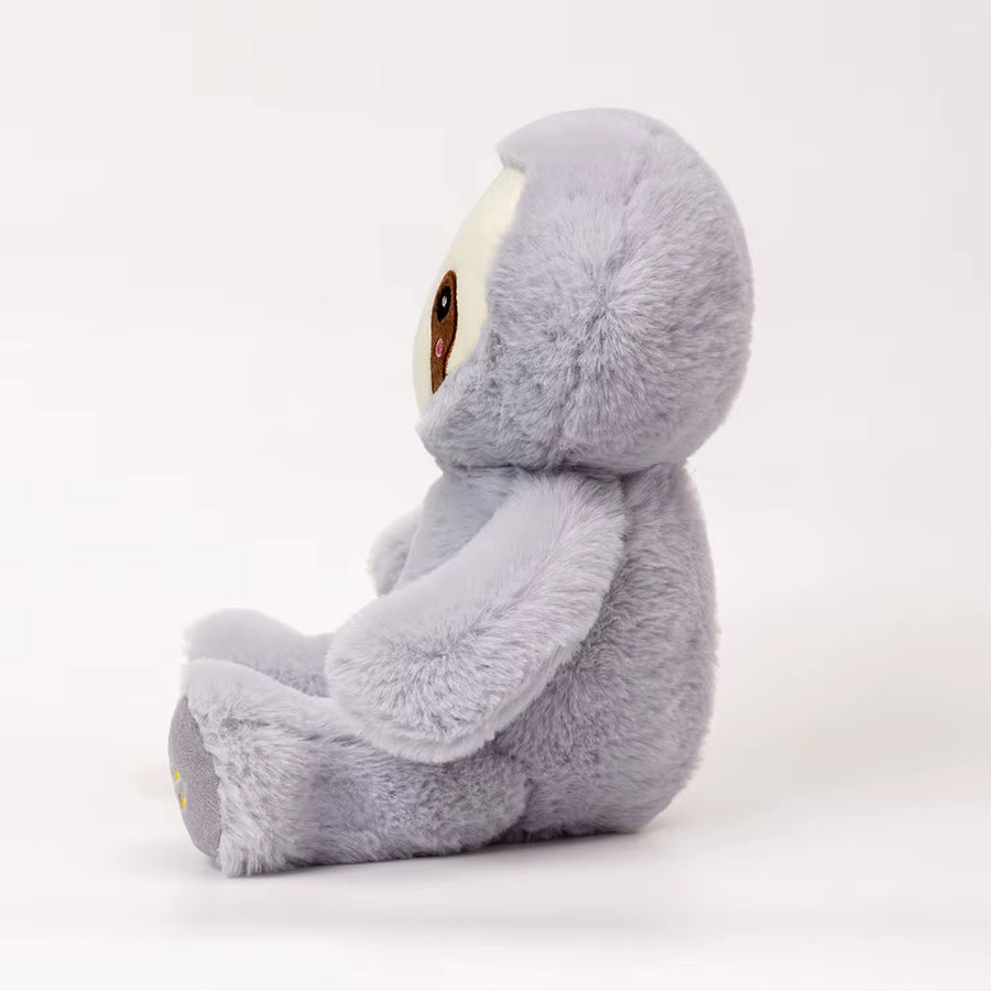 Side view of breathing sloth plush toy showing soft fabric and shape, calming stuffed animal designed for kids comfort and sleep support