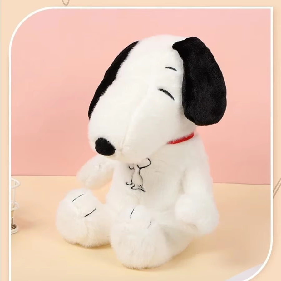 Child sleeping peacefully beside the breathing Snoopy plush toy