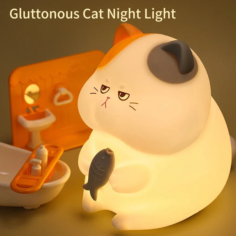 Gluttonous cat night light touch lamp glowing softly on a table