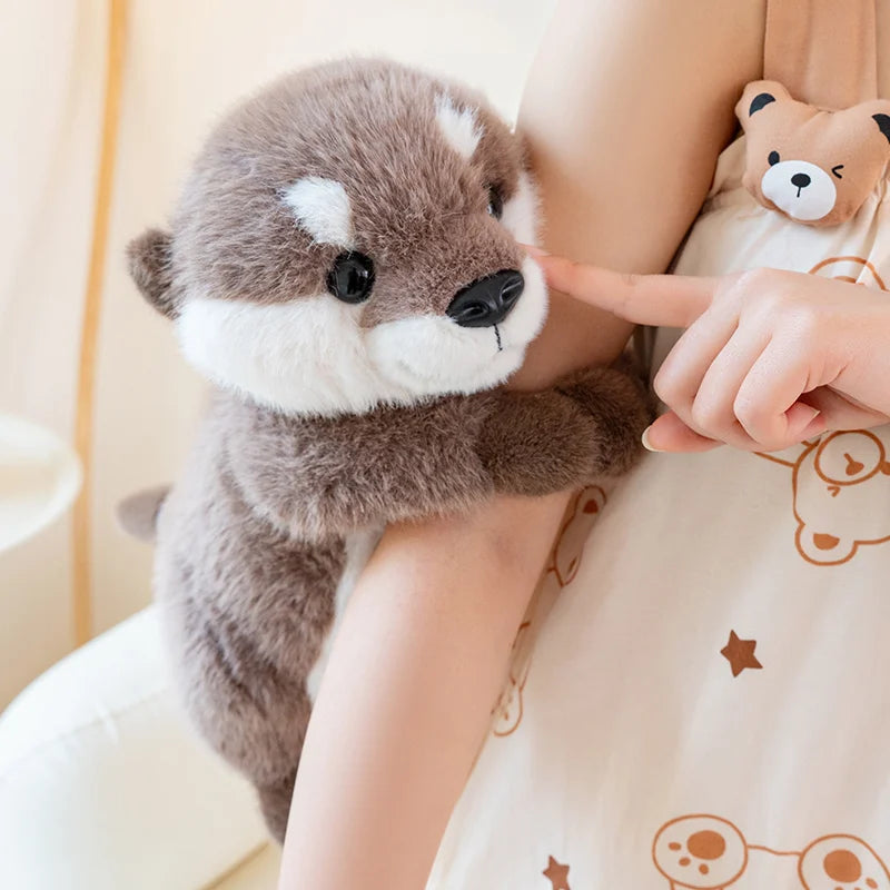 Ollie the Otter™ plush toy being held and cuddled, soft sea animal stuffed toy for kids offering comfort, emotional support, and cozy playtime