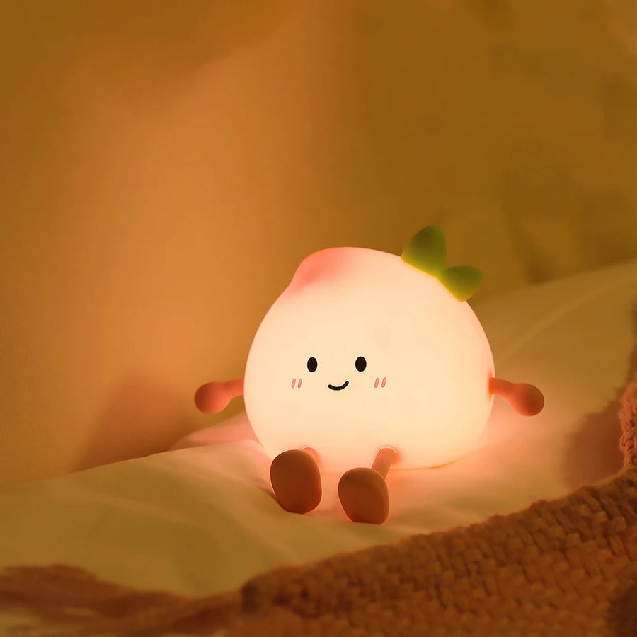 Peach night light glowing softly in a dark bedroom