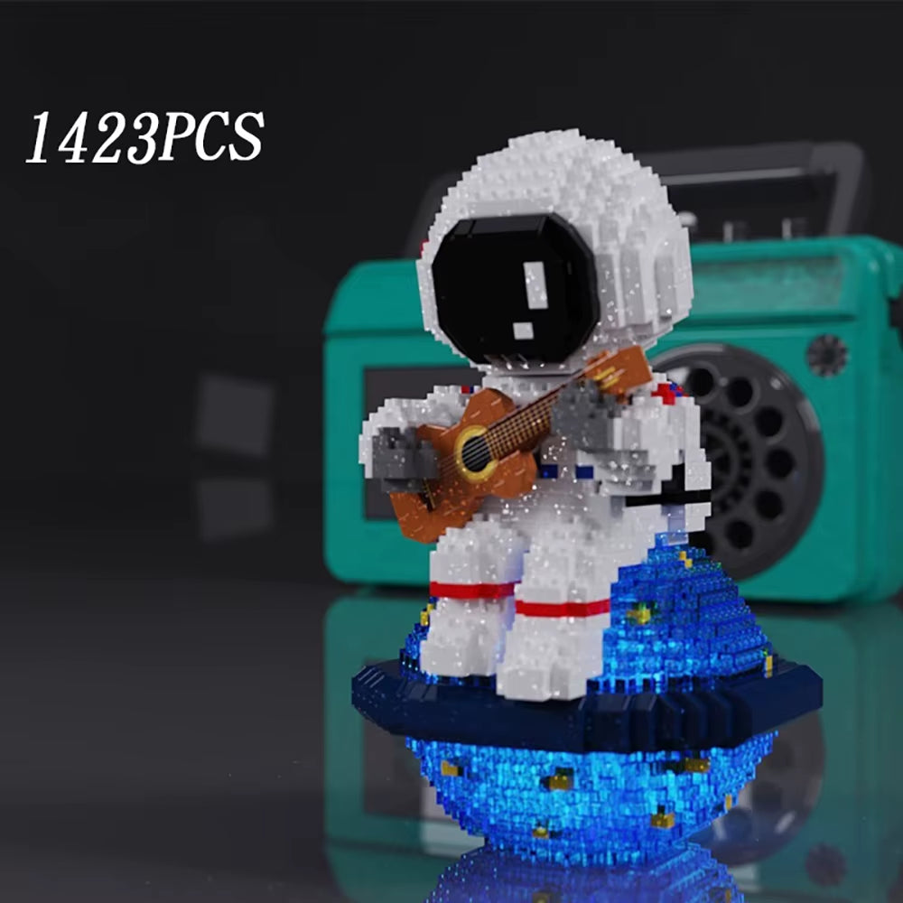 1423 piece astronaut guitar building block model with LED base displayed on reflective surface