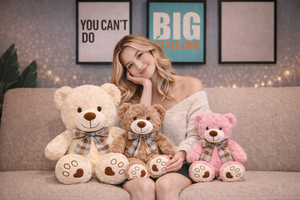 Woman sitting on a couch with three teddy bears in front of framed pictures.