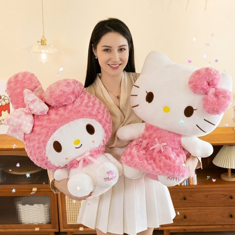 A woman holding two large plush toys, including a pink My Melody on the left and a pink Hello Kitty on the right, in a warm indoor room setting.