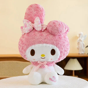 Pink plush toy with a bow on a neutral background