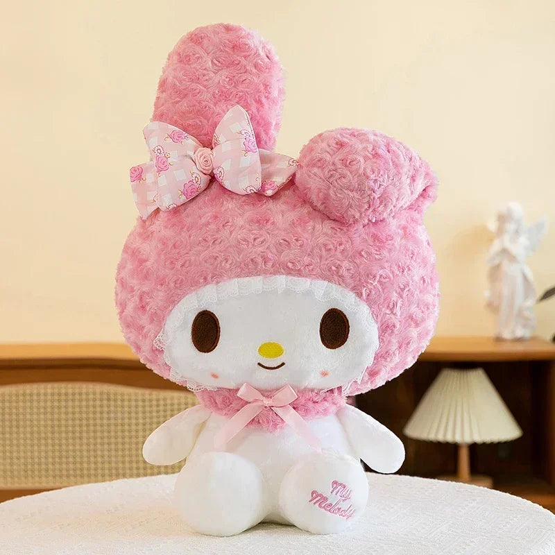 Pink plush toy with a bow on a neutral background