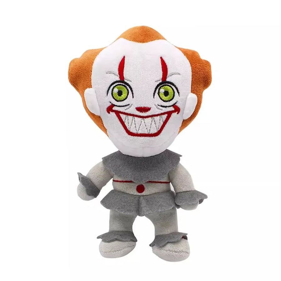 A Pennywise the Clown plush toy with orange hair, a white face, green eyes, and a wide red grin, wearing a gray and white outfit against a plain white background.