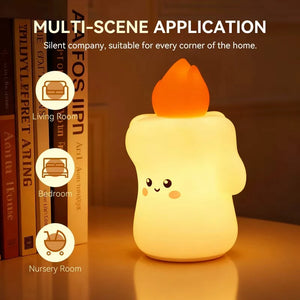 Candle-shaped night light glowing softly on a bedside table