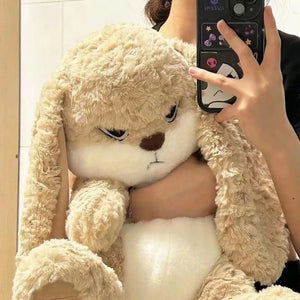 Kawaii angry rabbit plush placed on a bed as playful decor