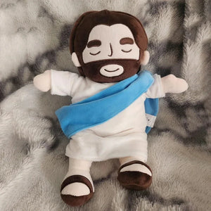 Breathing Jesus plush glowing softly in a dark room