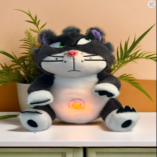 Breathing Lucifer cat plush toy with glowing light feature placed in a cozy home setting, calming anxiety relief stuffed animal for sleep and decor