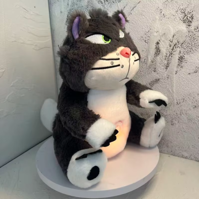 Side view of breathing Lucifer cat plush toy with soft glowing light, showing calming anxiety relief feature and comforting sleep aid design