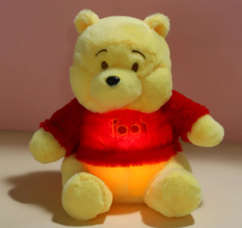 Breathing Winnie the Pooh plush toy shown resting comfortably on a bed