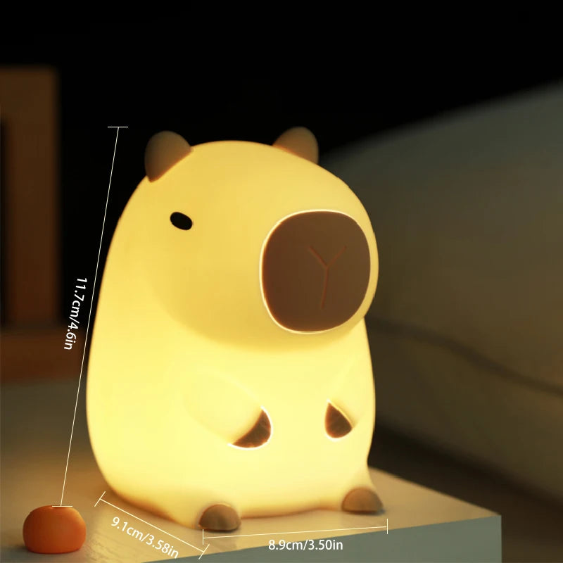 Capybara silicone night light connected to a USB charging cable