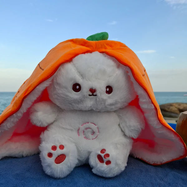 Carrot radish bunny breathing plush toy sitting on the beach