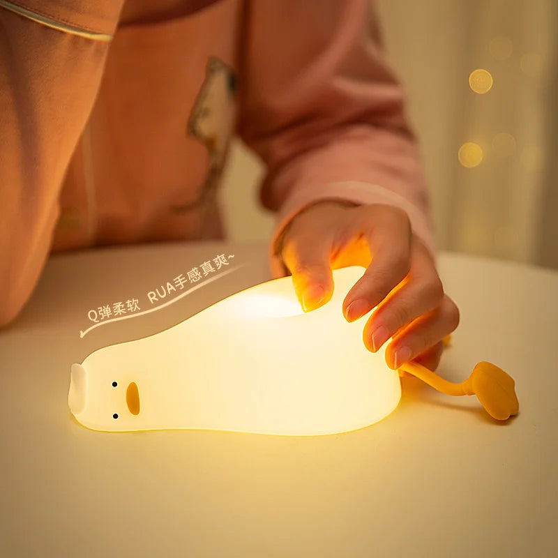 Cute duck night light glowing softly in a dark bedroom