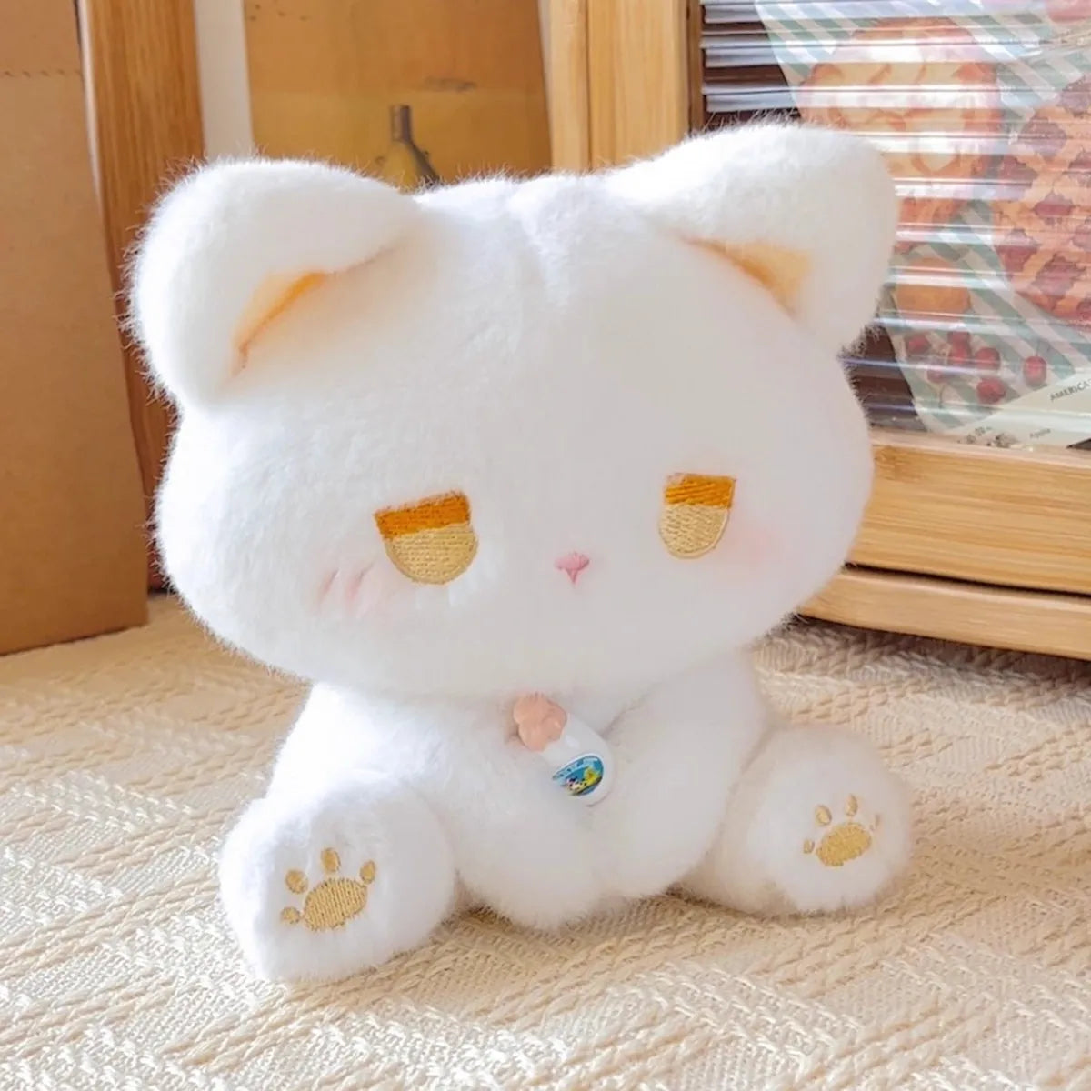 Emo cat plush placed on a bed as a comforting and quirky companion