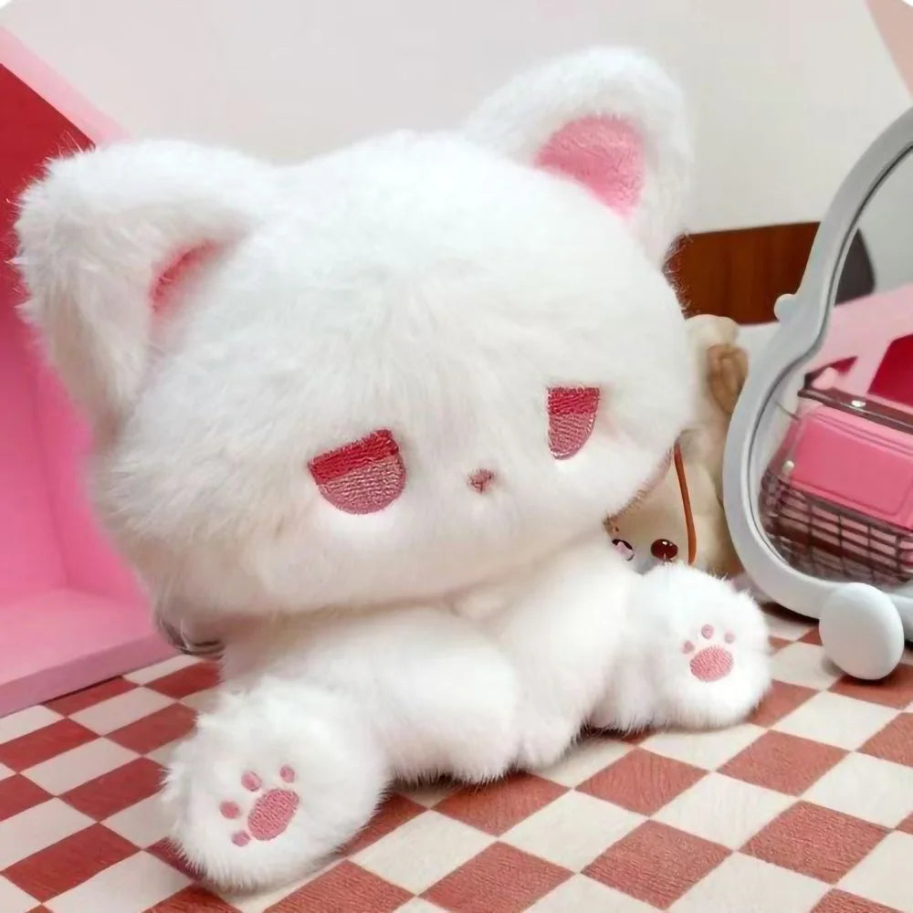 Emo cat plush used as quirky desk decor with a moody aesthetic