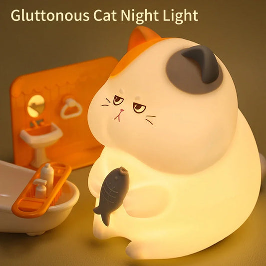 Gluttonous cat night light touch lamp glowing softly on a table