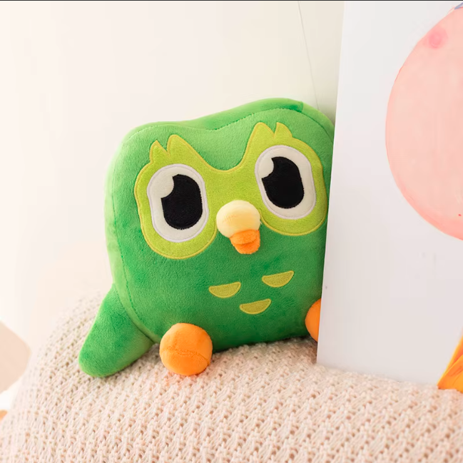 Cute kawaii owl plush toy sitting with soft green design