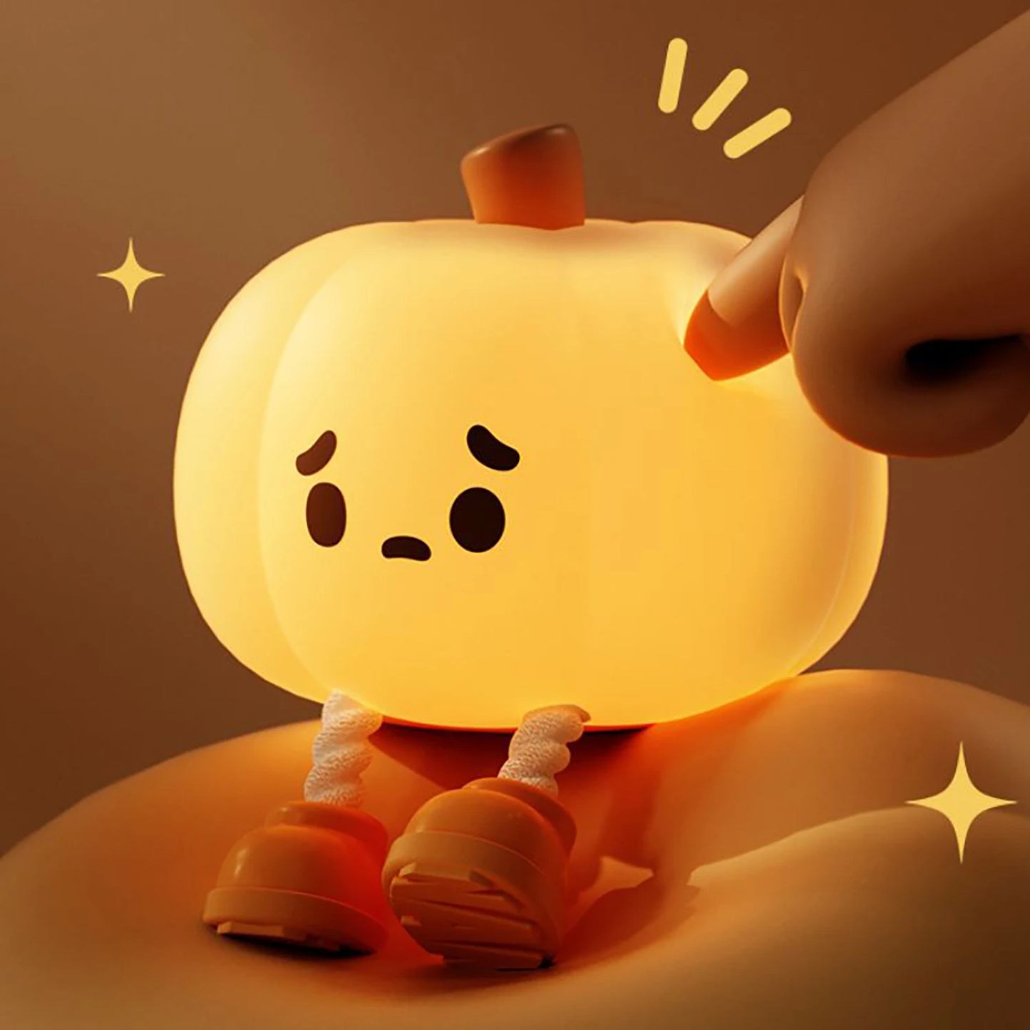 Cute little pumpkin night light glowing softly on a bedside table