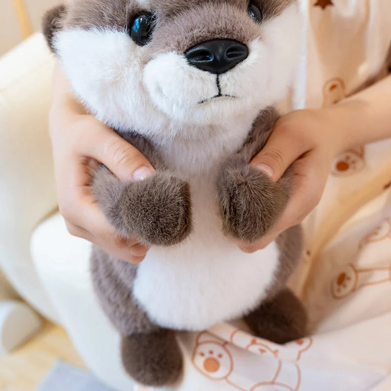 Close-up of Ollie the Otter™ plush toy being held in hands, soft cuddly sea animal stuffed toy for kids, comfort, gifts, and cozy playtime