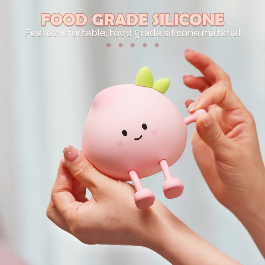 Hand touching a peach night light to adjust brightness