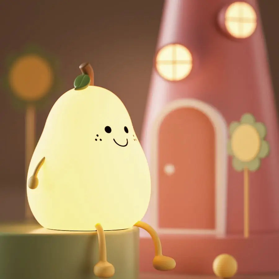 Pear night light glowing softly in a dark room
