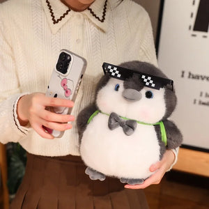 Close-up of the penguin plush couple showing their soft fabric texture