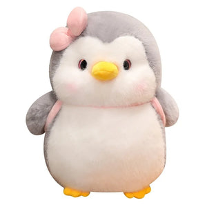 Penguin plush couple cuddled together showing their comforting softness