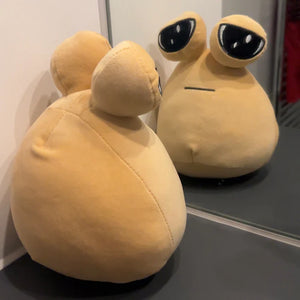 Pou plush toy shown from back and front in mirror, soft stuffed toy with simple cute design for kids