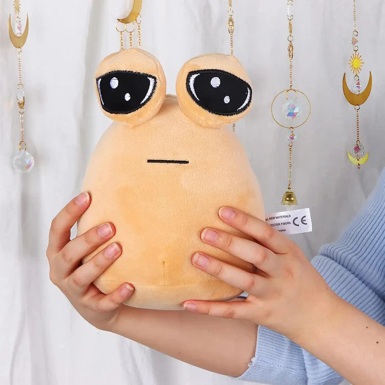 Pou plush toy held in hands showing softness and size, cute squishy stuffed toy for kids and gifts