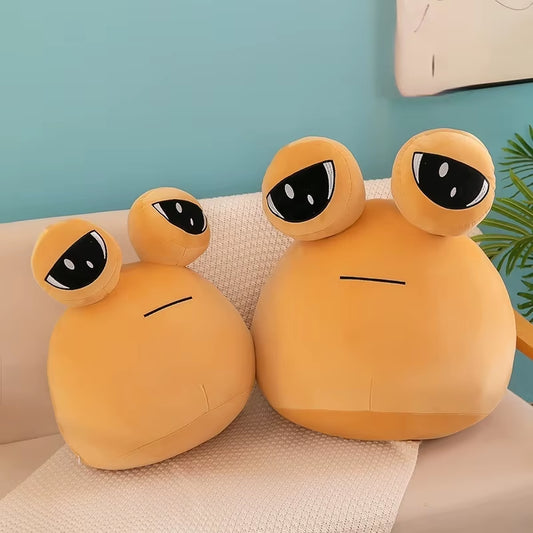 Pou plush toy with big eyes sitting on couch, soft cute stuffed pillow for kids and cozy room decor