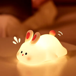 Big face rabbit night light glowing softly in a dark room