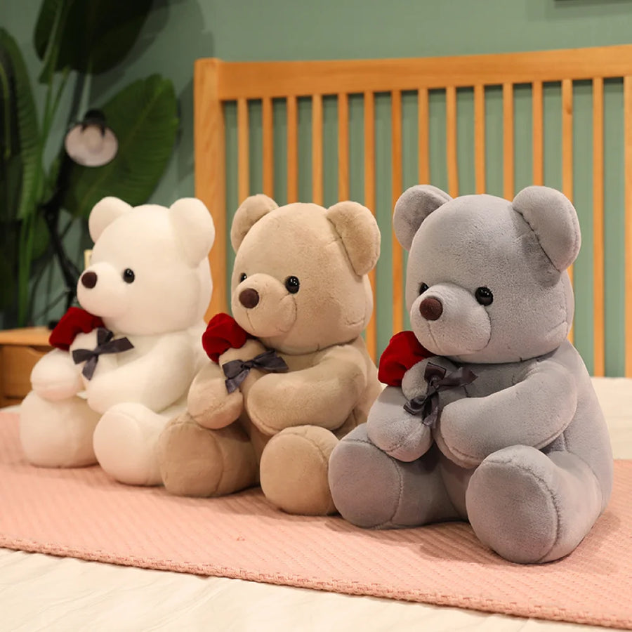 White, silver, and beige rose bear plush toys displayed together