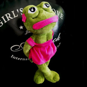 sad pepe frog plush toy wearing pink outfit standing on dark background