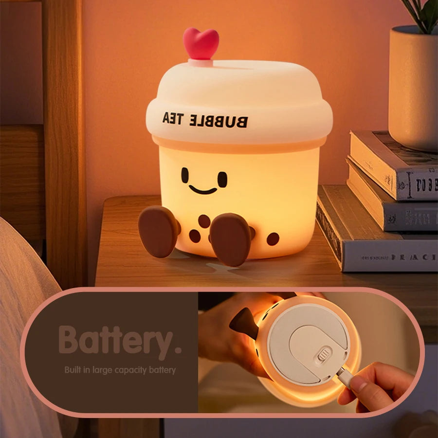 The Boba Night Light glowing on a bedside table with a close-up view of its rechargeable battery compartment.