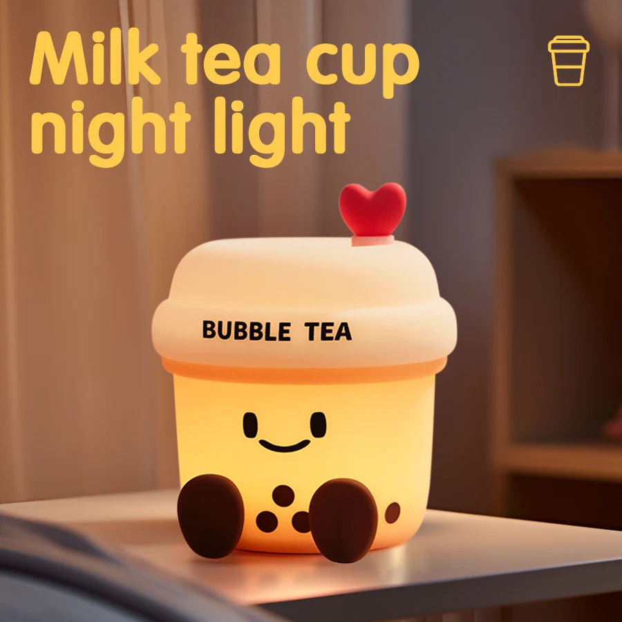 The Boba Night Light glowing warmly on a bedside table with a cute bubble tea design and heart-shaped top.