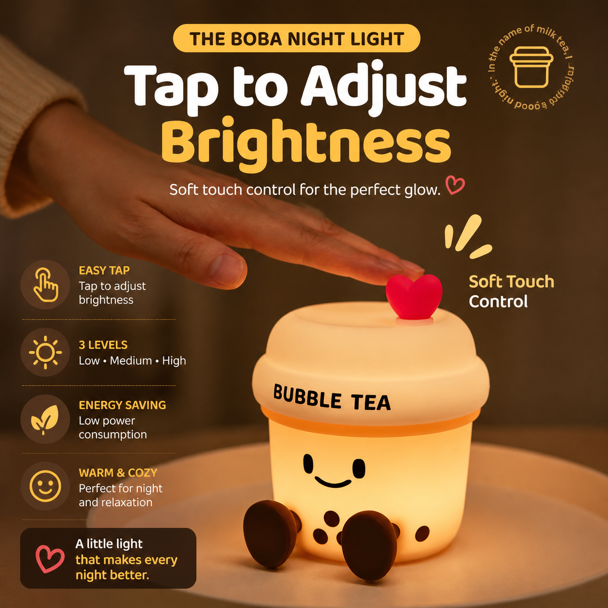 The Boba Night Light glowing warmly as a hand taps the heart button to adjust brightness with soft touch control.