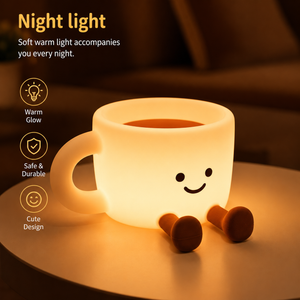 The Cozy Cup Night Light glowing warmly on a bedside table with cute smiling coffee cup design in a cozy nighttime setting