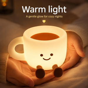 The Cozy Cup Night Light held in hands with a soft warm glow, creating a calming and cozy bedtime atmosphere for relaxing nights
